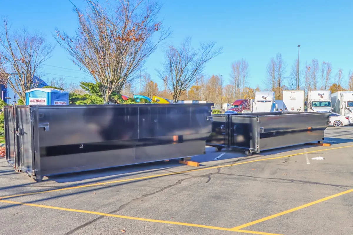 Professional dumpster rental service with roll-off container on residential driveway in Swarthmore